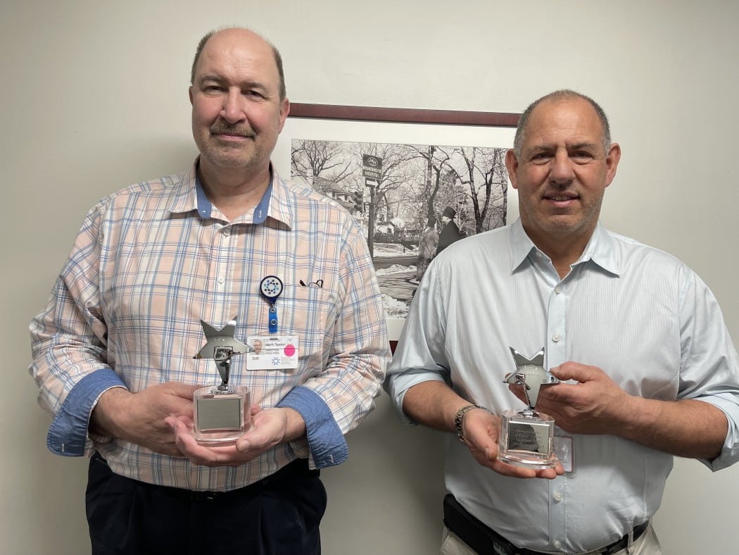 two men holding star awards