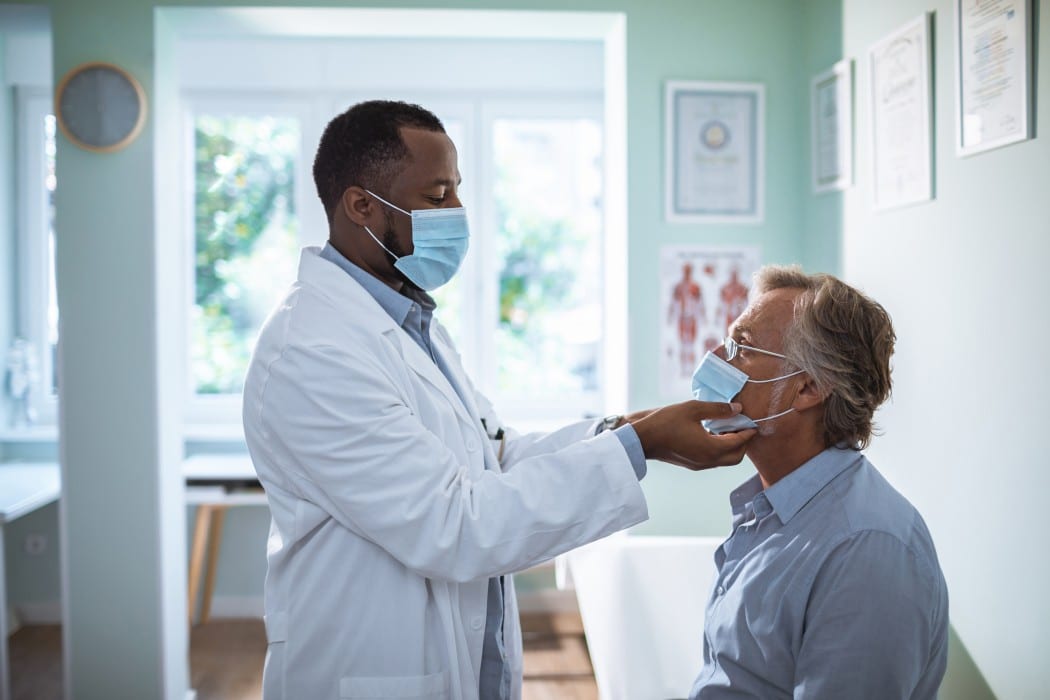 doctor checking on patients lymph nodes